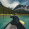 Young Man Canoeing on Emerald Lake