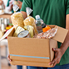 close up of volunteer holding box with food