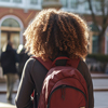 Schoolgirl walking with a backpack