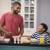 young father with his son making breakfast in kitchen