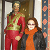 Woman standing beside marzipan figure of Michael Jackson