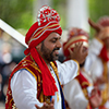  Indian men wearing traditional clothing, performing Bhangra traditional dance