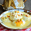 rasmalai on white and gold plate topped with dried fruit