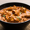 Murgh makhani / butter chicken tikka masala served with roti / paratha and plain rice along with oni