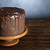 Delicious chocolate cake on the wooden surface. 3d render