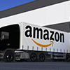Freight semi trucks with Amazon.com logo loading or unloading at warehouse dock. Editorial 3D render