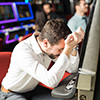  man feeling sad and stressed after losing his money playing slots in a casino