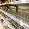 empty shelves with few canned goods left in a supermarket