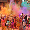 Group of people celebrating Holi - dusting of colours 