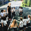 kids at elementary school playing with teacher