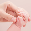 close crop of mother hand and baby hand