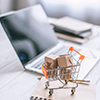 selective focus of decorative packages in toy cart on wooden desk