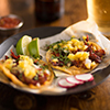 al pastor street tacos with pineapple, radish and beer