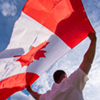Man holding the national flag of canada
