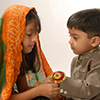Girl tying rakhi on wrist of boy on Rakshabandhan festival
