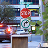 Burnaby, BC, Canada - May 30, 2018 : Motion of stop sign on sidewalk with blur traffic flow in Burna
