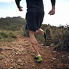 trail running athlete exercising for fitness and health outdoors on mountain pathway