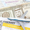 King Fahd on 1 Riyal Banknote in a map of Saudi Arabia over map, boarding pass and small toy airplan