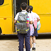 Group of school children boarding the school bus