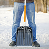Man with a snow shovel on the trails