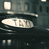 Vintage taxi in street in London at night.