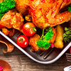 Thanksgiving items on wooden table - turkey, apple, leaves, candle