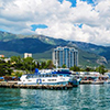 Scenic summer panorama of Black Sea pier and port harbor in Yalta, Crimea, Ukraine