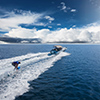 Speedboat with wakeboard rider on open sea