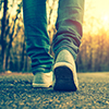 closeup of person's legs and shoes walking on street