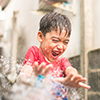 Little boy playing water splash