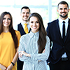 Happy business team with arms crossed at office