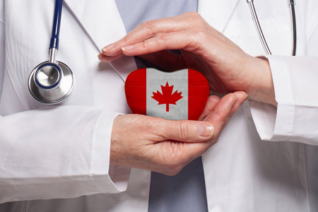 Canadian doctor holding heart with flag of Canada background. Healthcare, charity, insurance and med