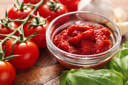 Bowl with tomato sauce on table