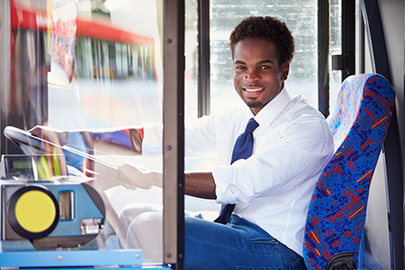 Portrait Of Bus Driver Behind Wheel