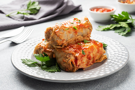 Cabbage rolls with beef, rice and vegetables on the plate. Stuffed cabbage leaves with meat. Gray co