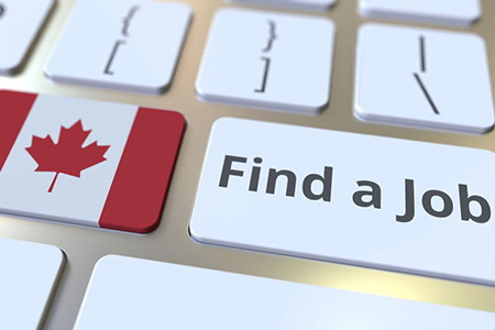 FIND A JOB text and flag of Canada on the buttons on the computer keyboard. Employment related conce