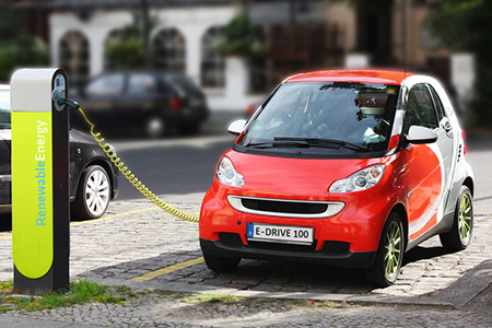 Red electric Smart Car charging