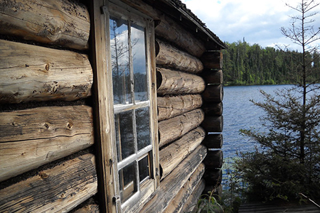 view of water behind log cabin