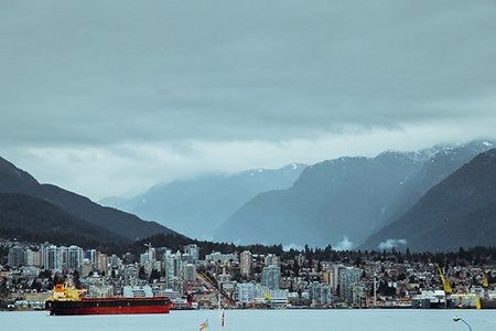 photo of vancouver taken from water - mountains visible in background