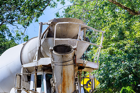 Cement truck mixer and pouring cement concrete in the morning