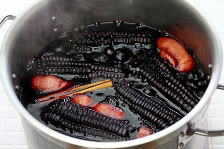 cooking chicha morada, a peruvian purple corn drink