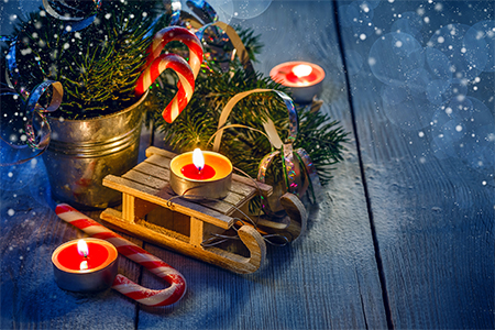 Christmas toy sledge, candy canes, candles and spruce branches