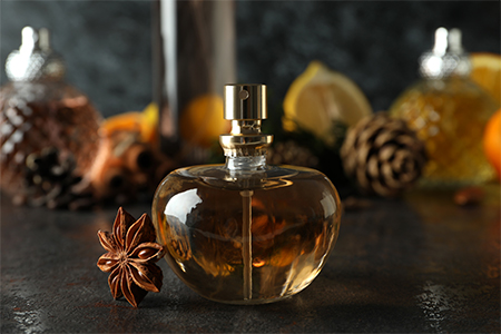 Composition with bottle of perfume, close up