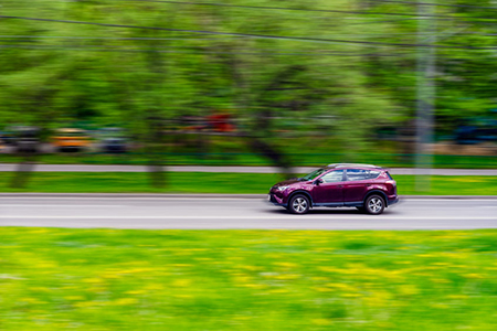 the Toyota RAV4 compact crossover moves at high speed along the street in summer. Moscow, Russia-Apr