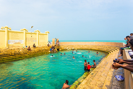 Keerimalai, Sri Lanka - February 5, 2015: Sri Lankan swimmers enjoy the Keerimalai Hot Springs, a to