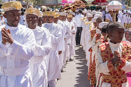 Jan 19: Ethiopian Orthodox Clergy and followers sing and chant while accompanying the Tabot, a model