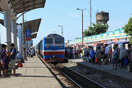 Passengers preparing to catch a diesel engine train at Vinh railway station