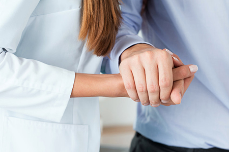 personal support worker holding hand with someone - cropped view of hands only