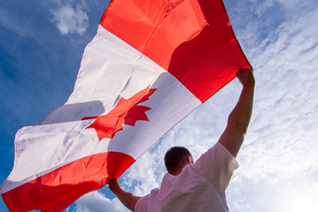 Man holding the national flag of canada