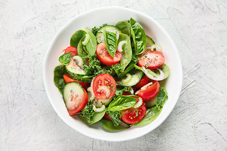 top view of fresh bright salad in white bowl